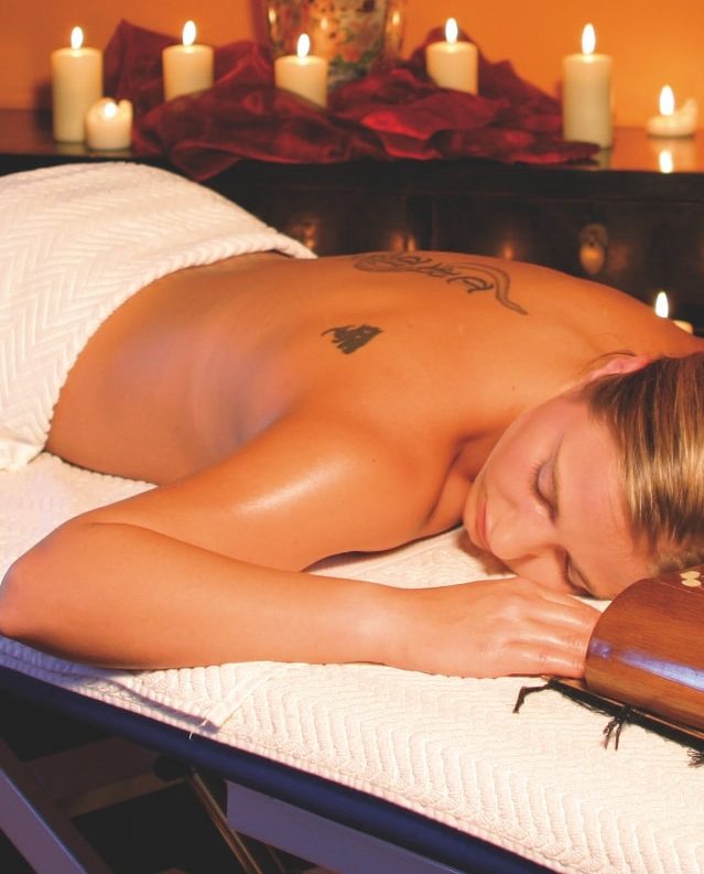 a woman lying on a massage table